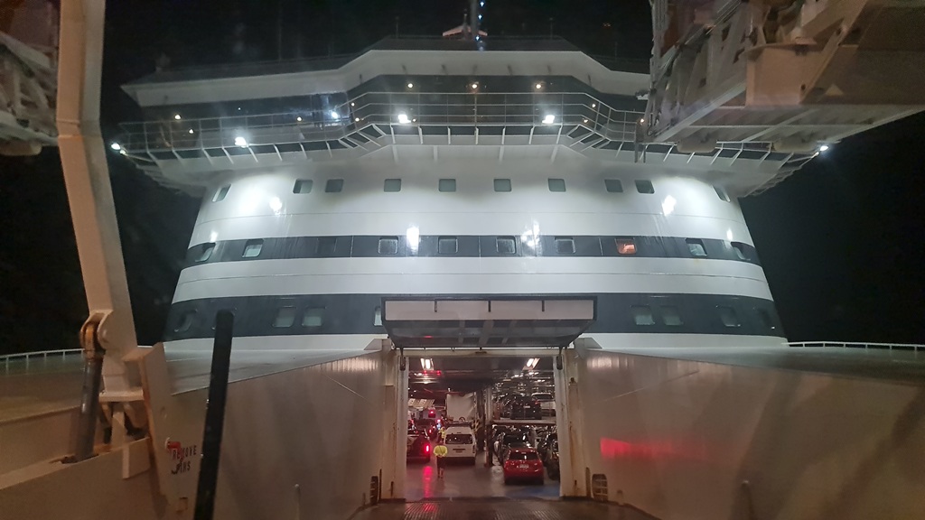 View from the driver's seat of a Ford Ranger towing a caravan onto the vehicle deck of the Spirit of Tasmania