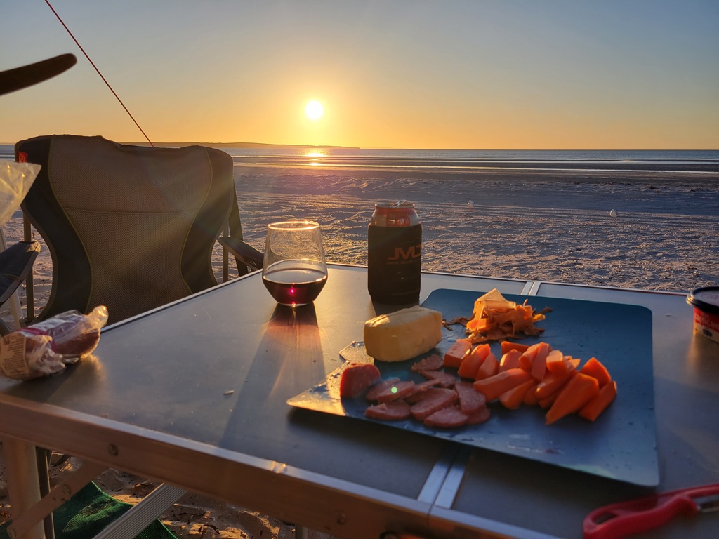 Enjoying the sunset on Perlubie Beach with win, beer and cheese