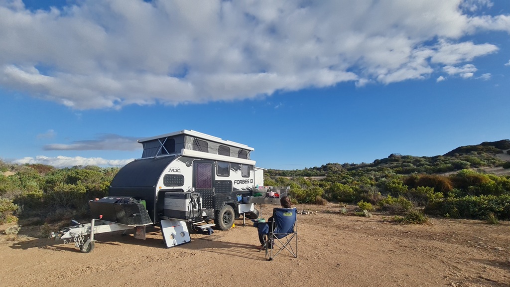 A small caravan set up at Woolshed Cave Campground