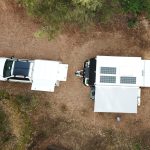 Caravan Solar Panel Efficiency: 7 Free Ways to Boost Your Power Aerial view of fixed caravan solar panels on a small off-road van and tow vehicle.