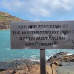 Cape York Itinerary The iconic 'You are standing at the northernmost point of the Australian Continent' sign at Pajinka, Cape York, with the Torres Strait in the background.