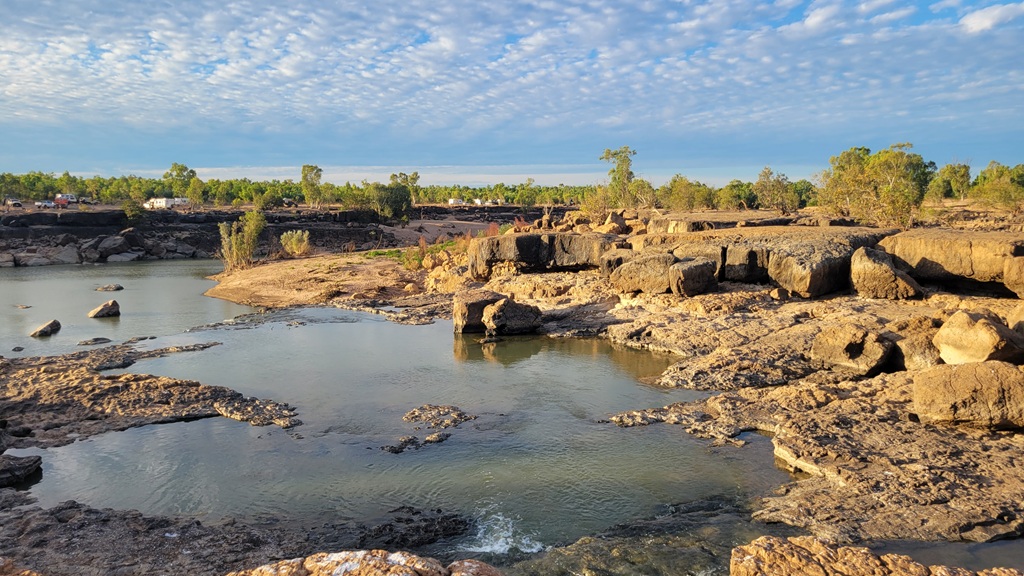 View across the rocky Leichhardt Falls riverbed toward the remote freedom camping area in the Gulf Country, Queensland.