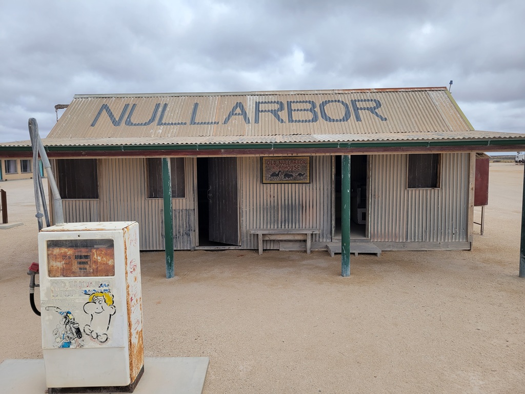 The historic old Nullarbor Roadhouse with a vintage fuel bowser in the foreground, captured during a South Australia road trip across the Eyre Highway, representing the remote outback history of the Nullarbor Plain.