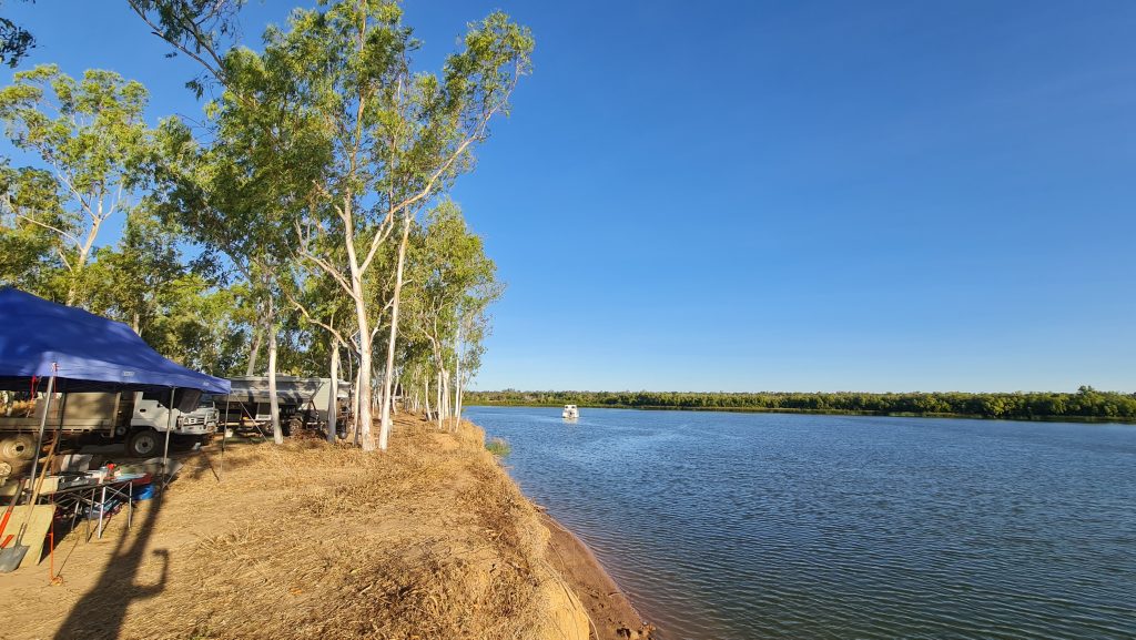 King Ash Bay camping in the Northern Territory on the Savannah Way, overlooking calm McArthur River under a clear blue sky.