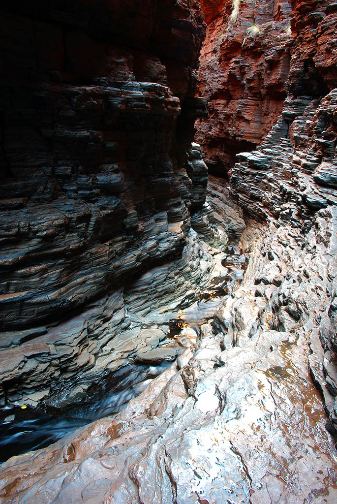 Sheer banded iron formation walls flanking the deep chasm of Knox Gorge